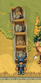 Two Wooden Carts placed vertically in a chain, each loaded with stone resources, sitting on a stone road between a settlement and a Material Storage building with an Automatic Scorpio turret visible on the perimeter